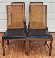 Front angled view showing all four chairs, cane backs, seat upholstery