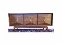 Front view showing diamond drawer fronts and brass pulls