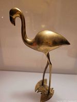 Full side view of brass flamingo on base
