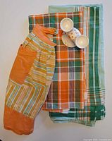 All three folded cotton tablecloths showing patterns and colors