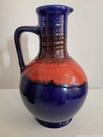 Front view of cobalt blue and red lava glaze jug