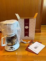 Coffee maker with carafe, box, cord, manuals