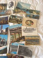 Spread of vintage postcards showing various cityscapes, coastal scenes and greetings