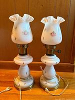 Front view of both milk glass lamps with shades