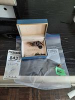 Open jewellery box with cufflinks and earrings; 14K earring in bag