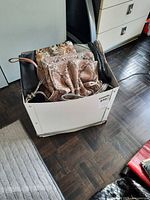 Box containing multiple handbags and pouches