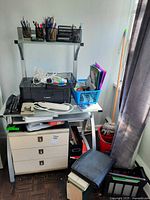 Overall view showing Canon printer, cords, telephone, desk organizers and drawers