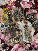 Overview of entire lot showing multiple trays filled with rings, earrings, necklaces, brooches and pendants