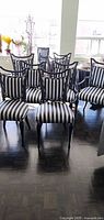 Front view of eight striped dining chairs