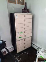 Full view of tall two-tone dresser, front drawers visible