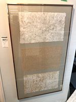 Full view of framed collage showing three handmade paper panels