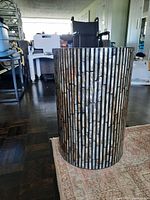 Full side view of cylindrical mosaic table