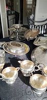 overview of silver-plated items on table