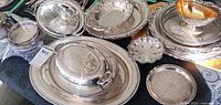 Group of silver-plated serveware items on table