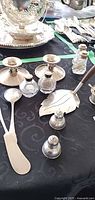 overview of silver candlesticks, shakers, server