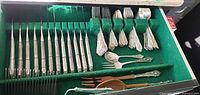 Drawer view showing full assortment of sterling handled knives, forks, spoons, serving pieces, wood salad set, cake breaker