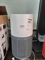 Front view of Winix air purifier with power cord visible