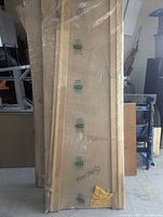 Stack of three plastic-wrapped prehung interior doors with frames