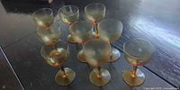 11 of the amber stemmed glasses displayed on tabletop