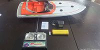 Boat, transmitter, battery and charger laid out