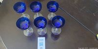 Group shot of all six cobalt blue stemmed glasses on table
