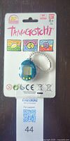 Front of sealed Tamagotchi 20th Anniversary keychain blister card