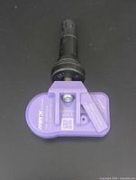 Close-up of one Max Gen 5 TPMS sensor showing purple housing and black rubber stem