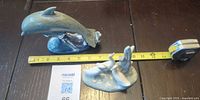 Whale and birds figurines with tape measure for scale