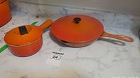 Saucepan and skillet with lids on marble counter