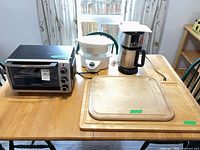 Overview of toaster oven, steamer, coffee maker, two cutting boards