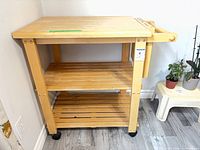 Full view of wooden cart showing top, shelves and casters