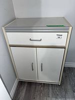 Front view of cabinet showing drawer and double doors