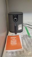 Front view of Ninja mini air fryer showing dial and handle