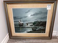 Front view of framed seascape oil painting with MaxSold sticker