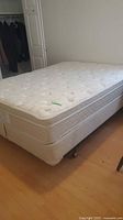 Queen mattress and box spring with rails, corner view
