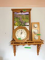 Full view of shelf, clock, weather station and calendar mounted on wall