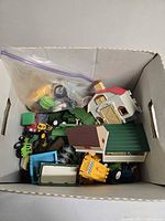 Overview of box contents showing vehicles, buildings and accessories