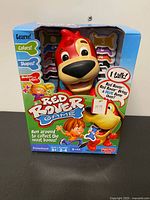 Front view of boxed Fisher-Price Red Rover Game showing dog unit and graphics