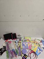 Overall lot view showing organizers, wands, books, sunglasses, headbands and jewelry case