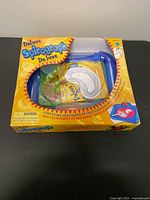 Front view of Hasbro Deluxe Spirograph box with contents visible