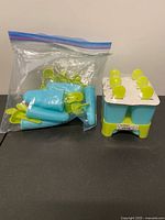 Both popsicle mold sets; one sealed, one open in Ziploc bag