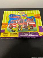 Front of puzzle box with image, piece count, finished size, age range