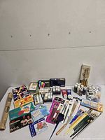 Full layout of paints, pastels, brushes, paper roll