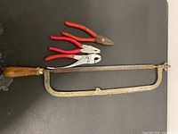 Hacksaw and three pliers overview