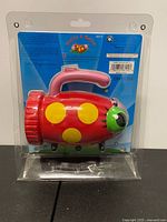 Front view of packaged ladybug flashlight showing brand and model