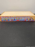 Closed wooden storage box showing side label and condition