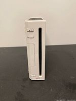 Front view of Nintendo Wii console showing disc slot and buttons