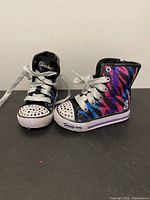 Full view of both sneakers standing upright