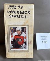 Closed card storage box with handwritten label and Eric Lindros card at front