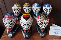 All seven masks displayed on stands